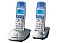 Фото-1 DECT‑телефон Panasonic KX‑TG2512RU: комплект из двух трубок на базах, ракурс 3/4; сине‑белые трубки, серебристые базы, синие дисплеи и цифровые клавиши; на белом фоне — важно показать комплектность (2 трубки) и цветовое сочетание корпуса.